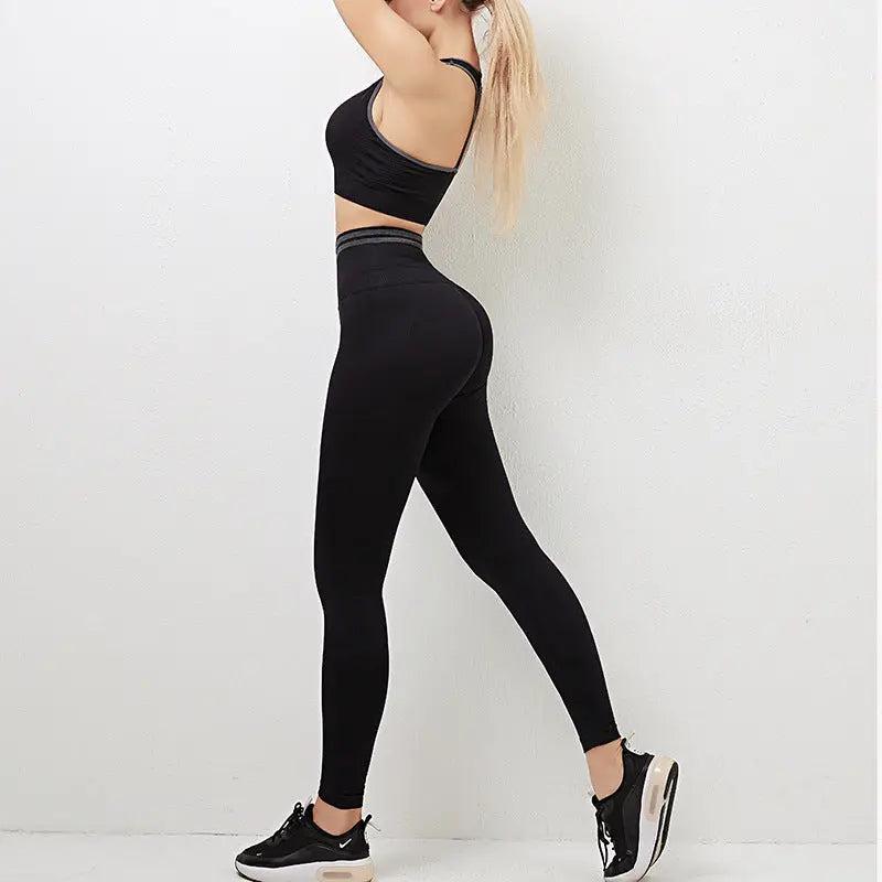 Caption: a woman in a black sports bra top and leggings