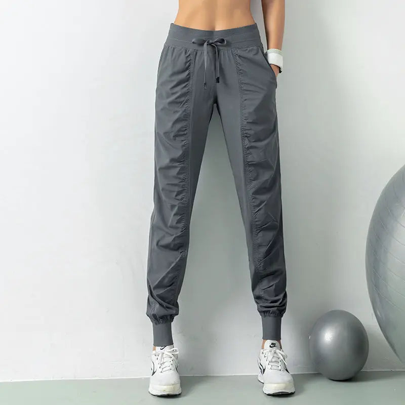 Stylish black fitness pants for women, perfect for workouts or casual wear. Slimming design with a loose fit for ultimate comfort.