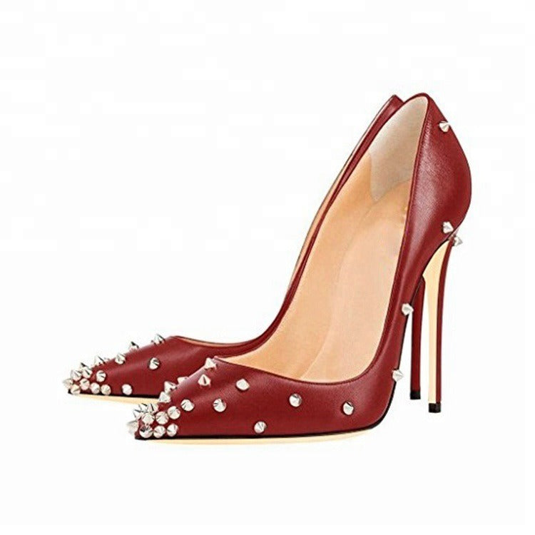 Red high heel pointed toe pumps with spike embellishments for women.