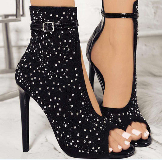 Black suede low-heel sandals with rhinestone embellishments and buckle closure.