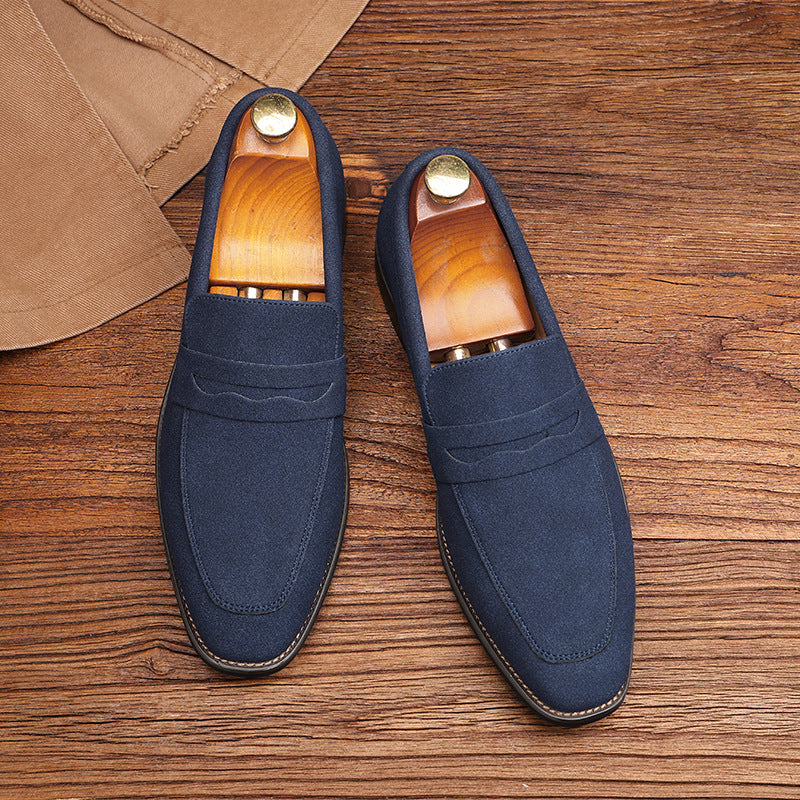 Close-up texture of the premium stitched penny strap and velvet suede surface on a high-end men's slip-on dress shoe.