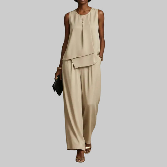 premium beige minimalist two-piece set featuring a high-neck sleeveless top and flowing full-length wide-leg trousers, styled as elegant resort daywear.