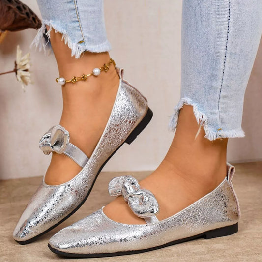 Women's metallic textured silver square toe ballet flats featuring an elegant matching bow strap
