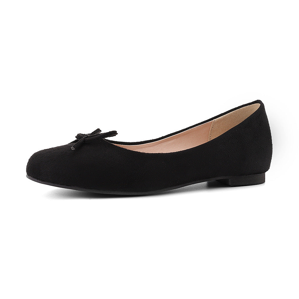 Black flat shoe with a bow on a white background