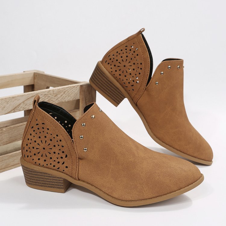 Pair of brown ankle boots with perforated design on a white background