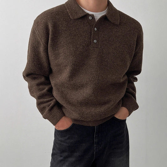 Person wearing a brown sweater with a white background