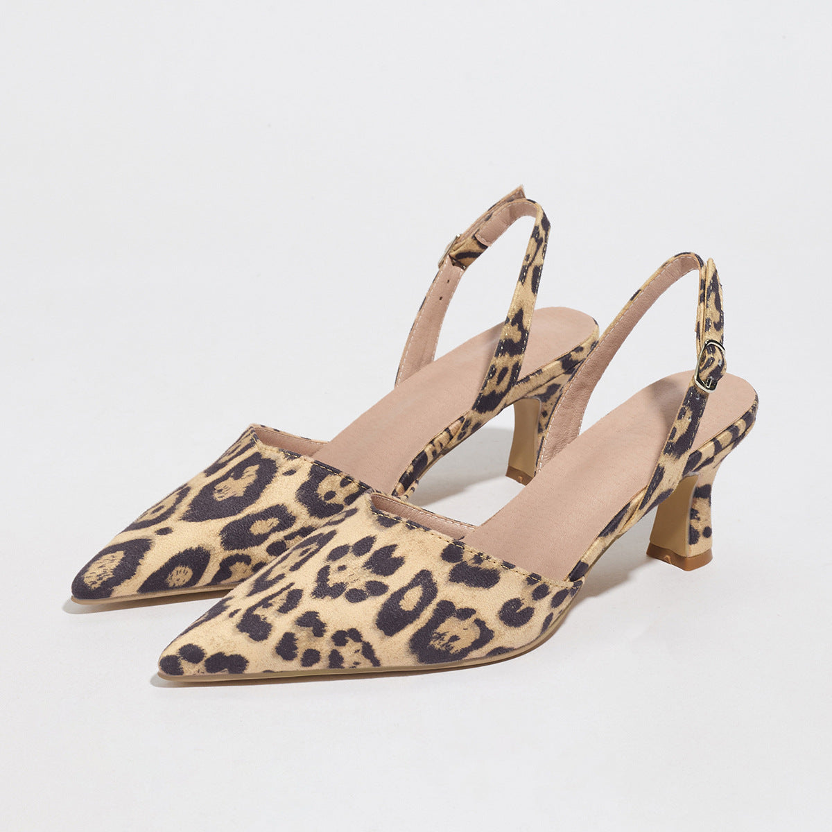 Pair of leopard print slingback heels on a light gray background