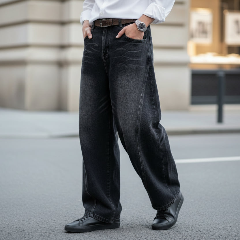 Man wearing relaxed wide-leg black trousers with silver luxury watch and minimalist white shirt, boutique fashion photography.