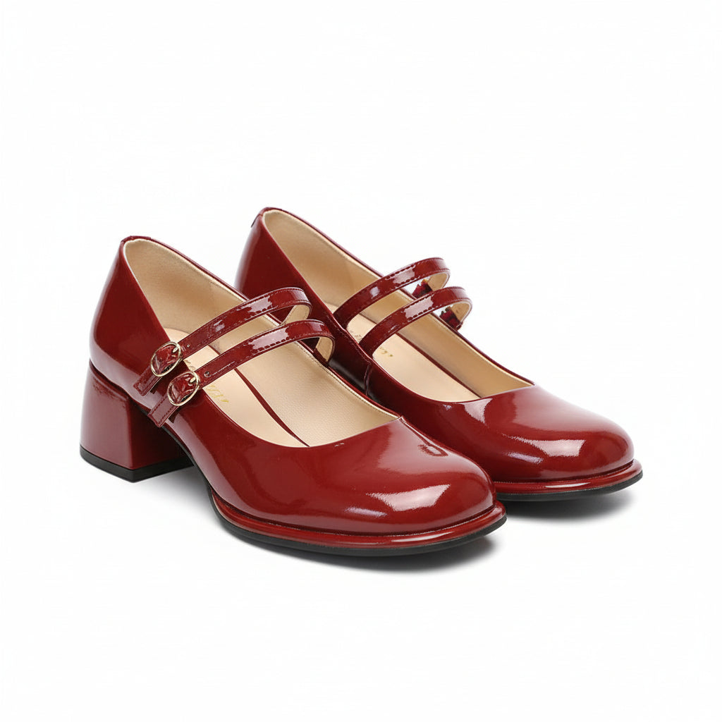Side view of French-style Mary Jane pumps with a mid-height chunky heel.