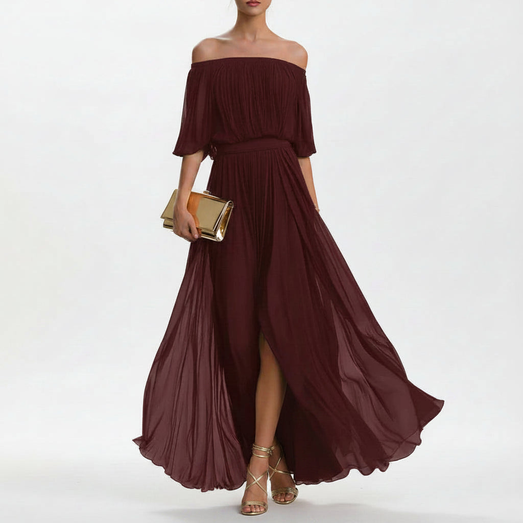Model wearing a white pleated chiffon off-shoulder maxi dress with a side slit.