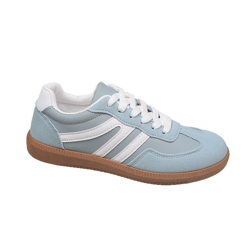 Light blue sneaker with white stripes and brown sole on a white background