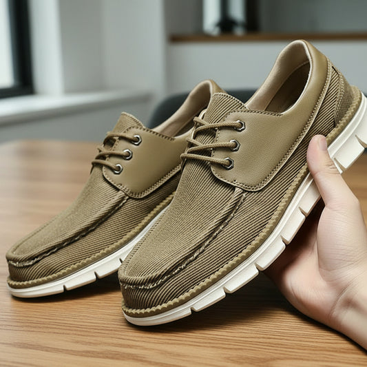 Pair of brown casual shoes on a reflective surface with a dark background