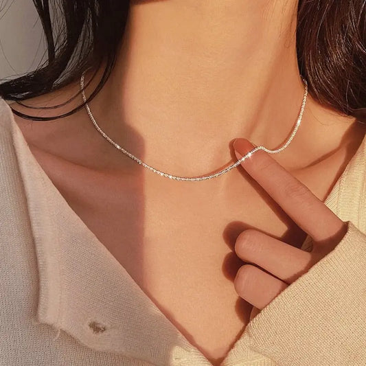 Sparkling necklace chain with intricate design, perfect for adding a touch of elegance to any outfit.